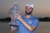 Chris Kirk holds the trophy after winning the Honda Classic golf tournament in a playoff against Eric Cole, Sunday, Feb. 26, 2023, in Palm Beach Gardens, Fla. (AP Photo/Lynne Sladky)