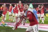 Manchester United's Lisandro Martinez celebrates with the trophy after the English League Cup final soccer match between Manchester United and Newcastle United at Wembley Stadium in London, Sunday, Feb. 26, 2023. (AP Photo/Alastair Grant)