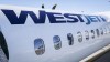 A WestJet plane waits at a gate at Calgary International Airport in Calgary, Alta., Wednesday, Aug. 31, 2022. WestJet customers say they were rebooked on a seven-and-a-half-hour bus trip from Calgary to Regina after their flight was cancelled Sunday. THE CANADIAN PRESS/Jeff McIntosh