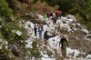 People walk along a trail partially covered in snow at the Deukmejian Wilderness Park, a rugged 709-acre site in the foothills of the San Gabriel Mountains, at the northernmost extremity of Glendale, Calif., Sunday, Feb. 26, 2023. (AP Photo/Damian Dovarganes)
