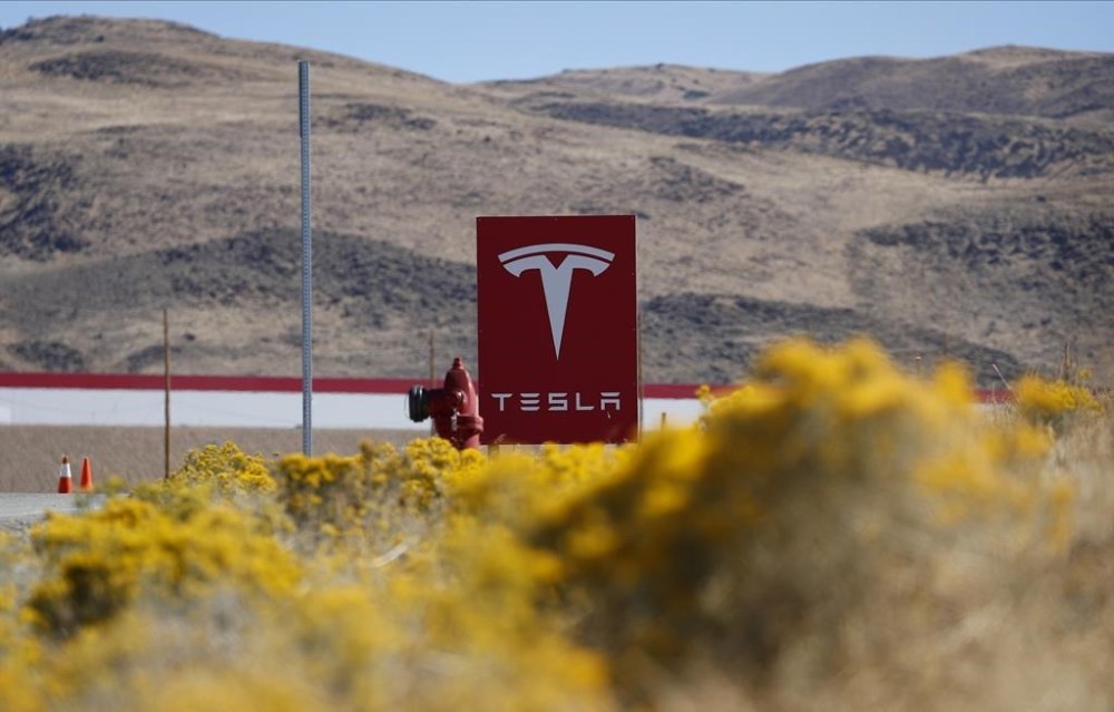 FILE - A sign marks the entrance to the Tesla Gigafactory in Sparks, Nev., on Oct. 13, 2018. Tesla may receive over $300 million in tax abatements over the next two decades for a massive new expansion of its northern Nevada facility, the product of a 2014 deal for when the company first came to the area on the promise of new jobs and major investments in the area. (AP Photo/John Locher, File)