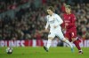 Real Madrid's Luka Modric, left, passes the ball past Liverpool's Roberto Firmino during the Champions League, round of 16, first leg soccer match between Liverpool and Real Madrid at the Anfield stadium in Liverpool, England, Tuesday, Feb. 21, 2023. (AP Photo/Jon Super)