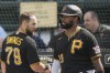 Pittsburgh Pirates' Chris Owings, left, talks with Canaan Smith-Njigba, right, after scoring during a spring training baseball game against the Baltimore Orioles, Tuesday, Feb. 28, 2023, in Bradenton, Fla. (AP Photo/Brynn Anderson)