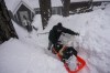 Angie Gourirand walks down the snow-covered steps of her home with groceries on a sled in Running Springs, Calif., Tuesday, Feb. 28, 2023. Beleaguered Californians got hit again Tuesday as a new winter storm moved into the already drenched and snow-plastered state, with blizzard warnings blanketing the Sierra Nevada and forecasters warning residents that any travel was dangerous. (AP Photo/Jae C. Hong)