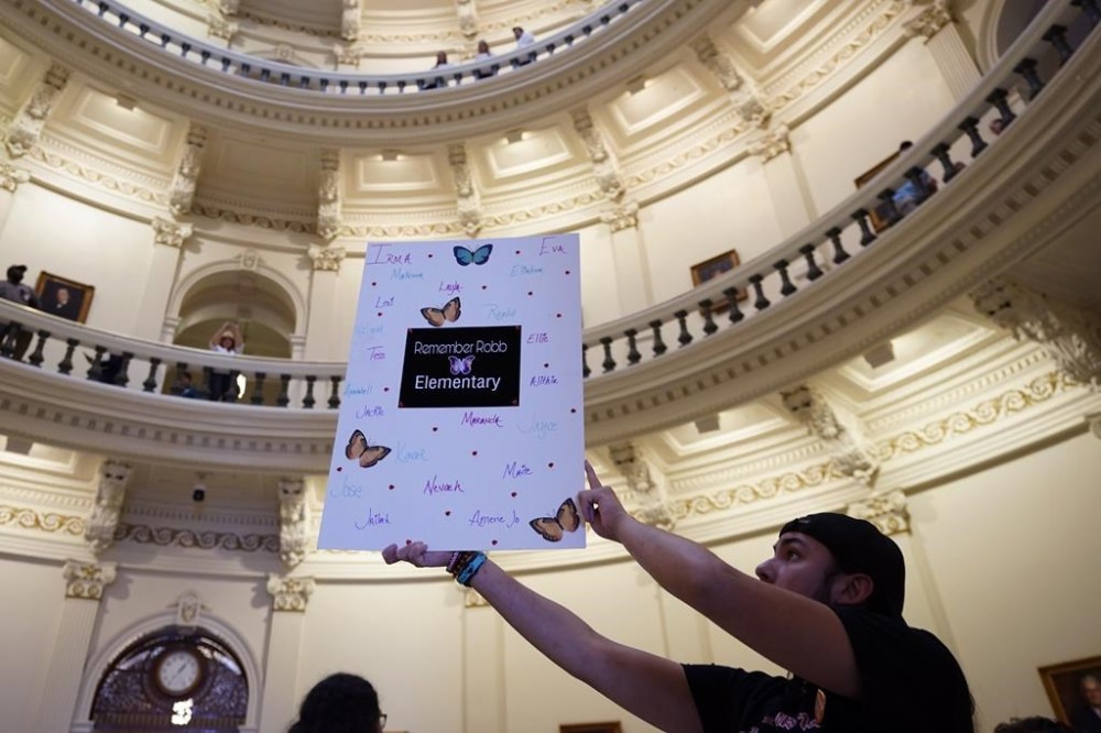 Eufemio Duran holds a sign honoring the victims to the shooting spree at Robb Elementary school as he and other dvocates for control gather at the Texas Capitol to call on Texas lawmakers to strengthen Texas' gun laws, in Austin, Texas, Tuesday, Feb. 28, 2023. (AP Photo/Eric Gay)