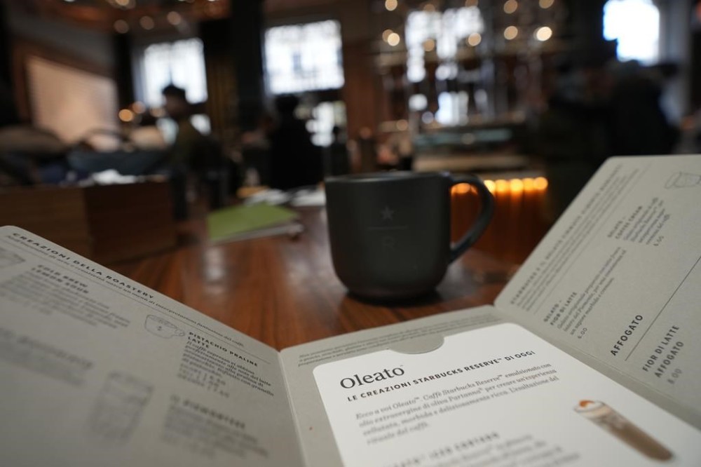 A view of the Oleato's menu at the Starbucks coffee shop in Milan, Italy, Monday, Feb. 27, 2023. Putting olive oil in coffee is hardly a tradition in Italy, but that didn't stop Starbucks founder and CEO Howard Schultz from launching a series of beverages doing just that in Milan, the city that inspired his coffee house empire. (AP Photo/Antonio Calanni)