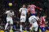 Atletico Madrid's Jose Gimenez, top right, heads the ball to scores his side's opening goal during a Spanish La Liga soccer match between Real Madrid and Atletico Madrid at the Santiago Bernabeu stadium in Madrid, Spain, Saturday, Feb. 25, 2023. (AP Photo/Manu Fernandez)