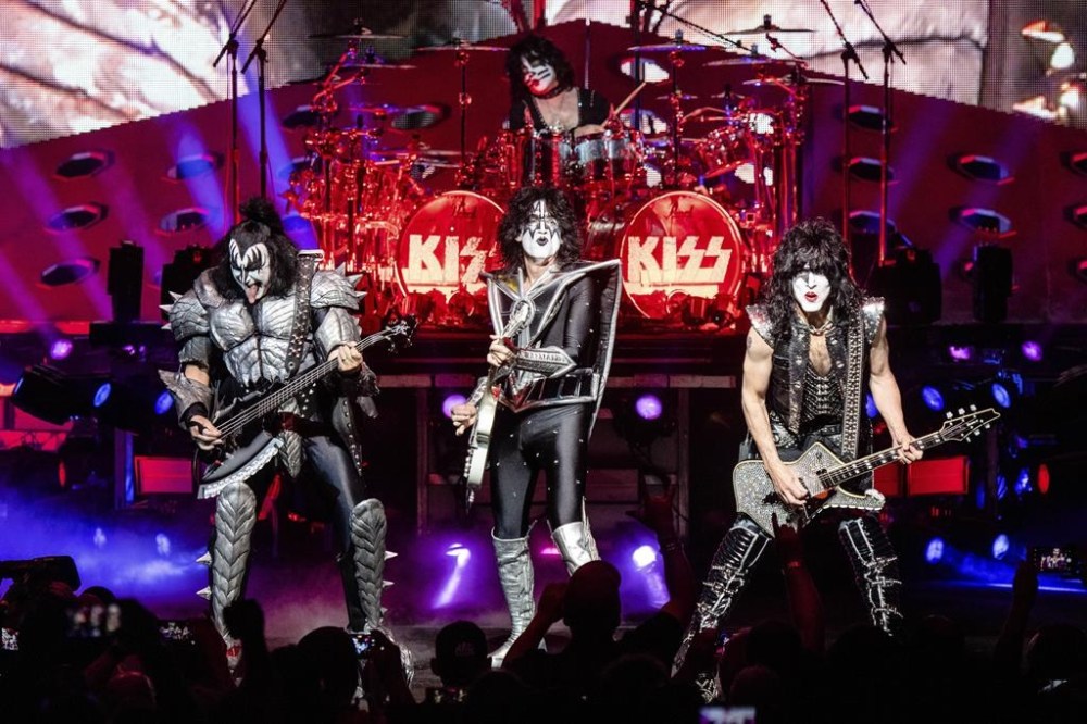 FILE - KISS, foreground from left, Gene Simmons, Tommy Thayer and Paul Stanley and Eric Singer on drum, performs at the the Riverbend Music Center in Cincinnati on Aug. 29, 2019. Kiss have announced the final shows of their last tour, planning to hang up their platform boots after two back-to-back shows at Madison Square Garden in New York at the end of 2023. (Photo by Amy Harris/Invision/AP, File)