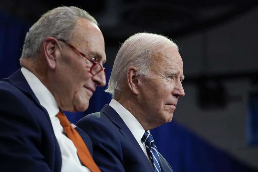 FILE - President Joe Biden and Senate Majority Leader Chuck Schumer of N.Y., left, listen during an event at Onondaga Community College, Oct. 27, 2022, in Syracuse, N.Y. Biden will meet with congressional Democrats starting Wednesday in back-to-back private sessions as their party confronts the limits of their power in a newly divided Washington with their once sweeping agenda effectively stalled. (AP Photo/Manuel Balce Ceneta, File)