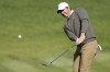 Rory McIlroy chips to the fourth green during the final round of the Genesis Invitational golf tournament at Riviera Country Club, Sunday, Feb. 19, 2023, in the Pacific Palisades area of Los Angeles. (AP Photo/Ryan Kang)