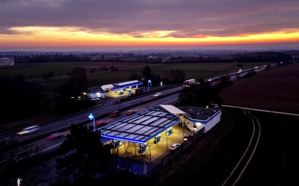 Gas stations are pictured on a highway near Frankfurt, Germany, before sunrise on Wednesday, March 1, 2023. (AP Photo/Michael Probst)