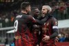 AC Milan's Theo Hernandez, right, celebrates with his teammates after he scored his side's first goal during a Serie A soccer match between AC Milan and Atalanta, at Milan's San Siro Stadium, Sunday, Feb. 26, 2023. (AP Photo/Antonio Calanni)