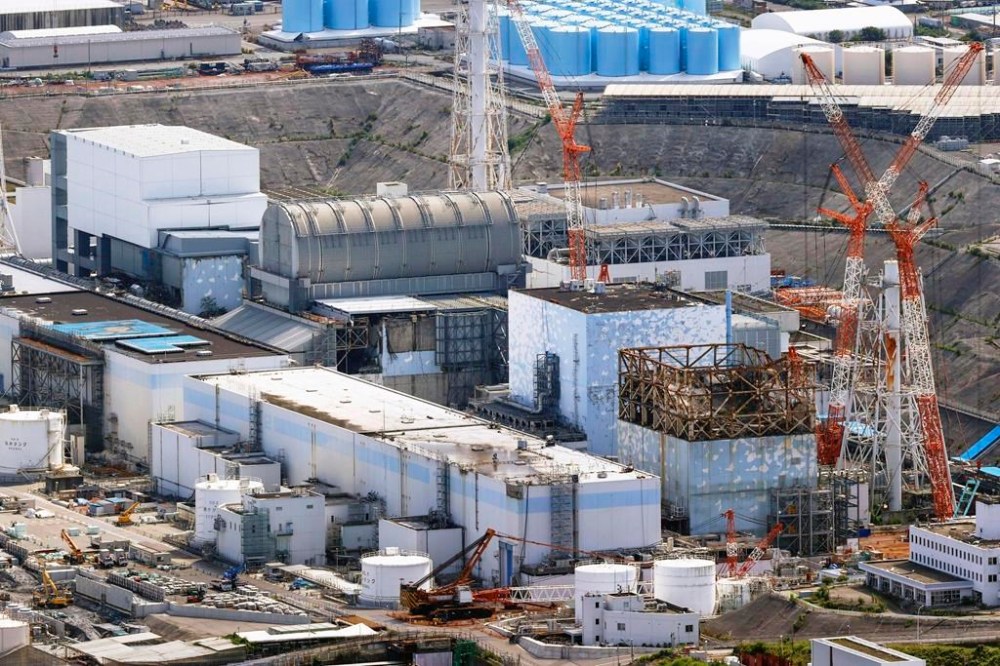 This aerial photo shows, from right to left, the Unit 1, 2, 3 and 4 reactor buildings of the Fukushima Daiichi nuclear power plant in Fukushima Prefecture on Aug. 21, 2022. Head of Japan’s tsunami-wrecked Fukushima Daiichi nuclear power plant says details of the damages inside reactors are only beginning to unravel 12 years after the meltdowns, making it difficult to foresee what the place looks like even 30 years from now. (Fumine Tsutabayashi/Kyodo News via AP)