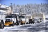 Utility service vehicles from multiple agencies stage in the paved parking lots of Grass Valley's Glenbrook Plaza as the storm cleared Wednesday, March 1, 2023, in Calif. Work will continue around the clock to restore power to the many who are still without electricity and heat in Nevada County. (Elias Funez/The Union via AP)