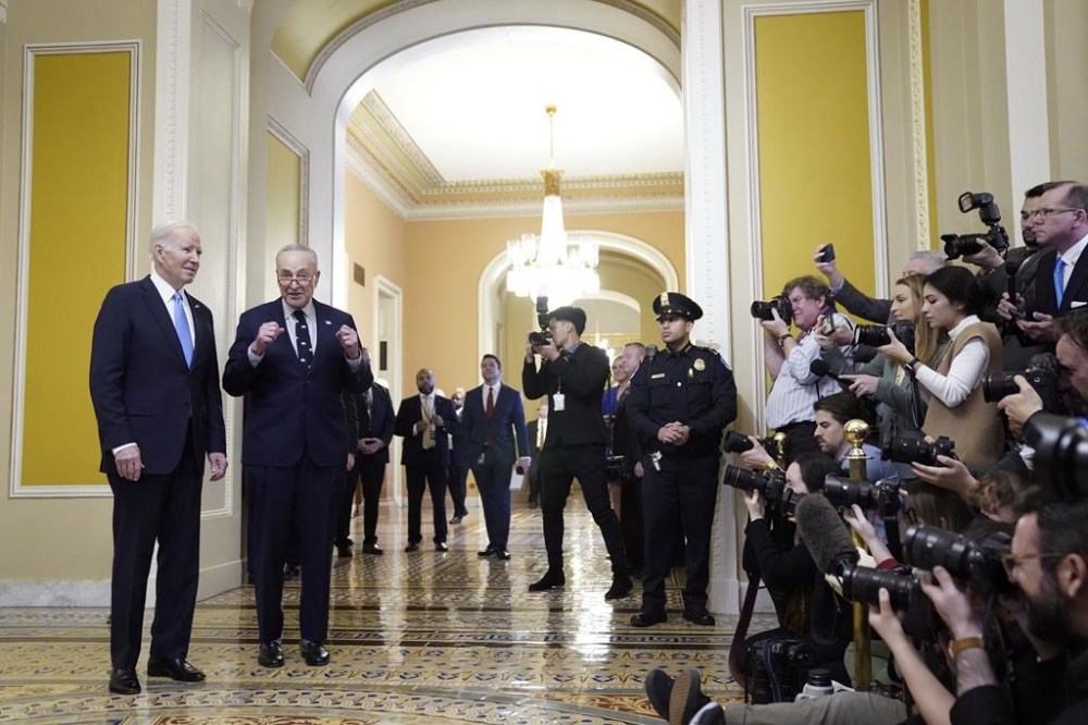 President Joe Biden listens as Senate Majority Leader Chuck Schumer of N.Y., speaks with reporters after Biden attended the Senate Democratic Caucus luncheon on Capitol Hill, Thursday, March 2, 2023, in Washington. (AP Photo/Evan Vucci)