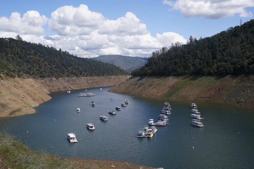 FILE - Houseboats sit in the drought-lowered waters of Oroville Lake, near Oroville, Calif., on April 19, 2022. After sitting at low levels for much of 2022, the reservoir was at 116% of its historical average on Thursday, March 2, 2023, after a series of winter storms. (AP Photo/Rich Pedroncelli, File)