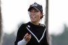 FILE - Danielle Kang shares a laugh with her caddie as she walks to the 18th green during the first round of the LPGA Hilton Grand Vacations Tournament of Champions, Jan. 19, 2023, in Orlando, Fla. Kang avoided distractions in a rain-soaked round and shot a 9-under 63 on Friday, March 3, 2023 for a one-shot lead after the second round of the Women's World Championship in Singapore. (AP Photo/John Raoux, File)