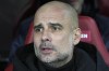 Manchester City's head coach Pep Guardiola sits on the bench during the Champions League round of 16 first leg soccer match between RB Leipzig and Manchester City in Leipzig, Germany, Wednesday, Feb 22, 2023. (AP Photo/Michael Sohn)