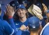 Toronto Blue Jays starting pitcher Kevin Gausman met by teammates in the dugout after throwing an inning of action against the Tampa Bay Rays in their spring training game in Dunedin, Florida on Friday, March 3, 2023. THE CANADIAN PRESS/Fred Thornhill