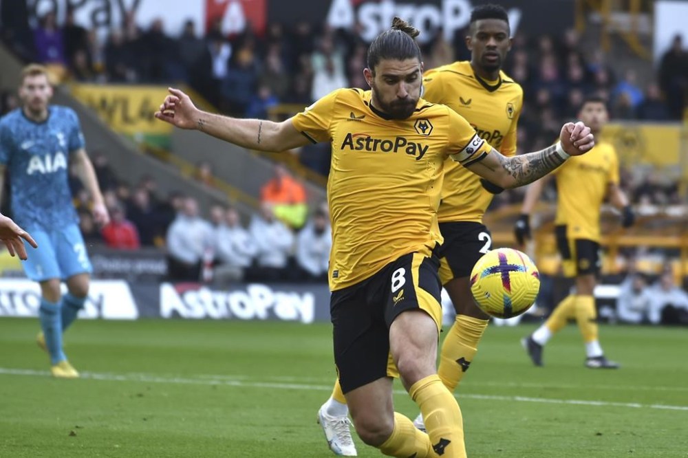 Wolverhampton Wanderers' Ruben Neves, centre, in action during the English Premier League soccer match between Wolverhampton Wanderers and Tottenham Hotspur at Molineux stadium in Wolverhampton, England, Saturday, March 4, 2023. (AP Photo/Rui Vieira)