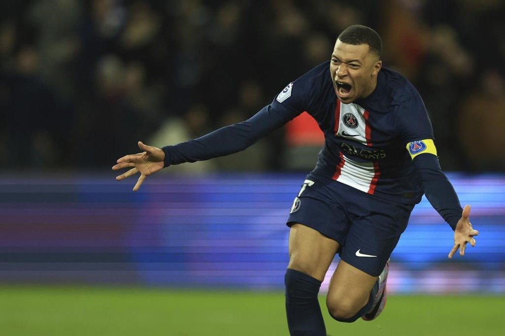 PSG's Kylian Mbappe celebrates after scoring his side's fourth goal during the French League One soccer match between Paris Saint-Germain and Nantes at the Parc des Princes in Paris, Saturday, March 4, 2023. (AP Photo/Aurelien Morissard)