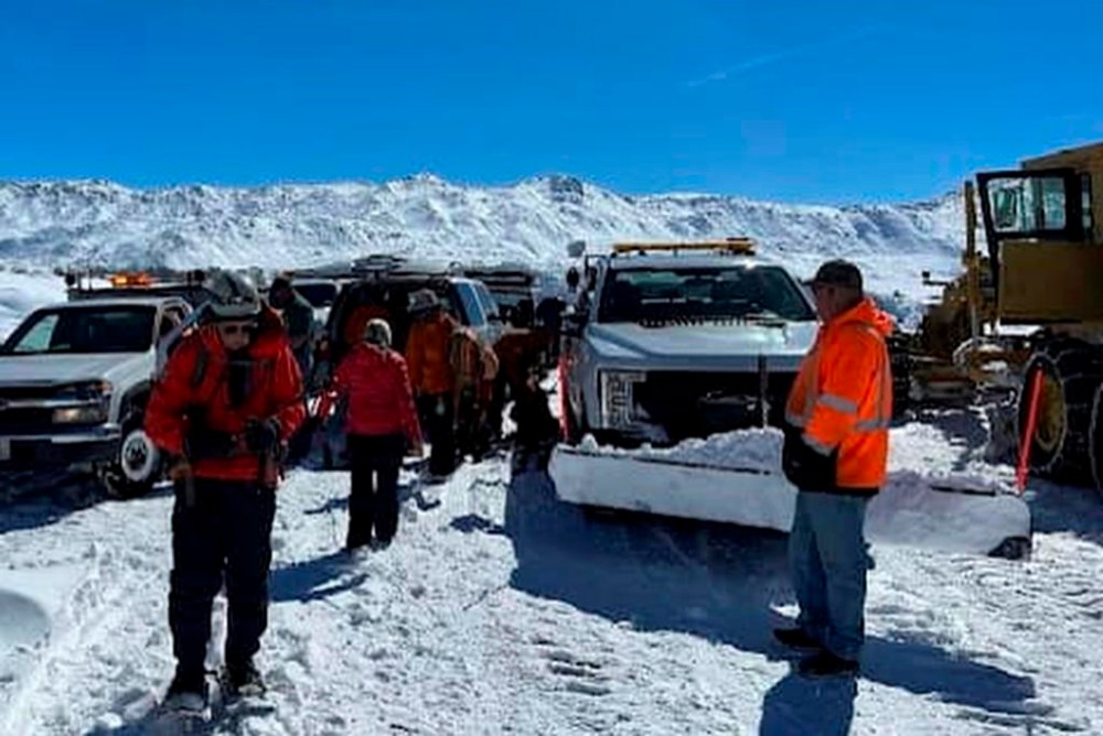 This March 2, 2023, image released by Inyo County Search and Rescue (InyoSAR) shows InyoSAR members search for a missing person near an area along Death Valley Road, a rough road running south of the 168, and leading into Death Valley National Park, Calif. The California Highway Patrol identified a cell phone ping linked to the missing person, Thursday, March 2, and sent a helicopter crew that spotted a partly snow-covered vehicle with the man waving inside, sheriff's authorities said in a statement. (InyoSAR via AP)