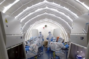 FILE - In this file photo released by China's Xinhua News Agency, staff members work in an inflatable COVID-19 testing lab provided by Chinese biotech company BGI Genomics, a subsidiary of BGI Group, in Beijing, June 23, 2020. BGI Group, one of the world's biggest genetics analysis companies, said Sunday, March 5, 2023, it never would be involved in human rights abuses after the U.S. government said there was a danger some of its units might contribute to Chinese surveillance. (Chen Zhonghao/Xinhua via AP, File)