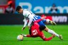 Leverkusen's Nadiem Amiri, right, and Hertha's Marc Oliver Kempf in action during the Bundesliga soccer match between Bayer Leverkusen and Hertha BSC at BayArena stadium in Leverkusen, Germany, Sunday, March 5, 2023. (Marius Becker/dpa via ap)