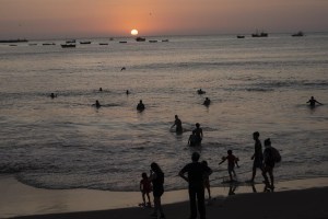 People bath in the Pacific Ocean at Agua Dulce beach at sunset in Lima, Peru, Wednesday, Feb. 8, 2023.&nbsp;Environmental groups are praising a newly signed treaty that will help protect biodiversity in the high seas, where conservation across the vast stretches across the planet have been hampered by a confusing patchwork of laws. THE CANADIAN PRESS/AP-Rodrigo Abd