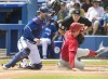 Philadelphia Phillies' Rhys Hoskins is out at home plate with the tag by Toronto Blue Jays catcher Danny Jansen in the first inning of their spring training game in Dunedin, Fla., Sunday, March 5, 2023. THE CANADIAN PRESS/Fred Thornhill