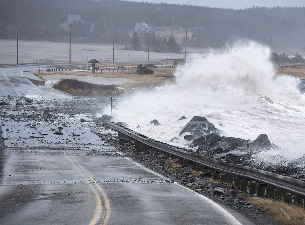 Waves pound the shore on a closed section of Highway 207 in Lawrencetown, N.S., on Friday, Jan. 5, 2018. Canada's spy service warns that climate change poses a profound, ongoing threat to Canada's security and prosperity, including the possible loss of parts of British Columbia and the Atlantic provinces to rising sea levels. THE CANADIAN PRESS/Andrew Vaughan