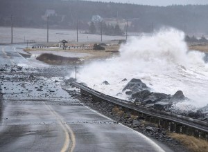 Waves pound the shore on a closed section of Highway 207 in Lawrencetown, N.S., on Friday, Jan. 5, 2018. Canada's spy service warns that climate change poses a profound, ongoing threat to Canada's security and prosperity, including the possible loss of parts of British Columbia and the Atlantic provinces to rising sea levels. THE CANADIAN PRESS/Andrew Vaughan