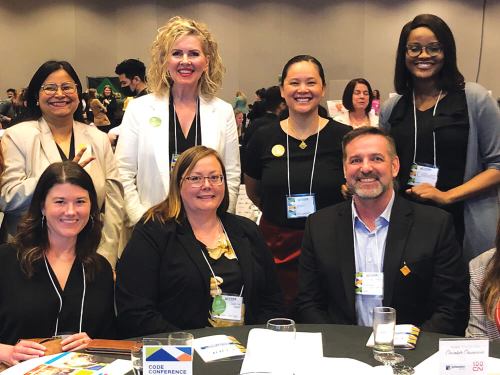Chaunika Reid (standing, right) and fellow Assiniboine Credit Union employees at the Winnipeg Chamber of Commerce, CODE Conference.