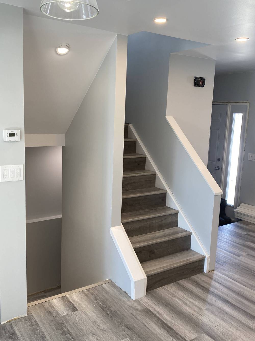 Numerous steps are required to create this finished staircase sheathed in vinyl plank that matches the newly installed flooring throughout. (Marc LaBossiere / Winnipeg Free Press)
