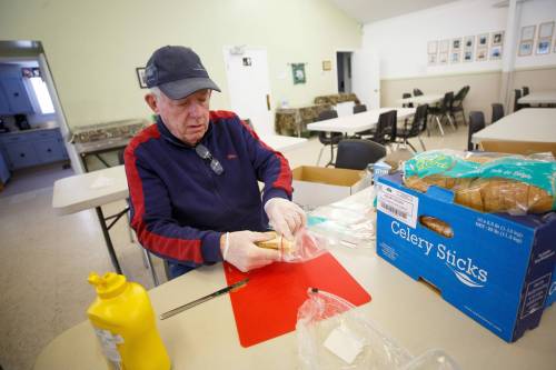MIKE DEAL / WINNIPEG FREE PRESS
                                Campbell McIntyre volunteers with numerous organizations including Rainbow Stage and his church, St. Saviours Anglican and its Gifts of Grace street mission, where he was helping make sandwiches on a recent afternoon.