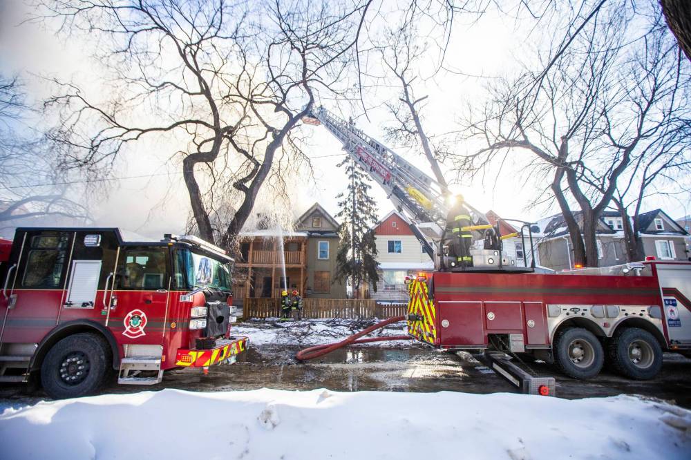 MIKAELA MACKENZIE / WINNIPEG FREE PRESS
Two neighbouring homes were evacuated, and the fire had to be fought from the outside — using an aerial ladder — because it was unsafe to enter.