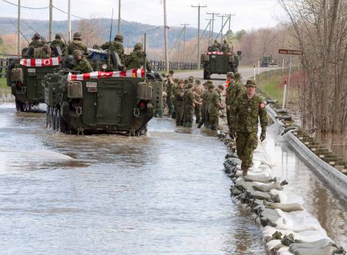 Ryan Remiorz / The  Canadian Press
                                Canadian Forces soldiers lay down sandbags to reinforce a highway in Saint-Andre-d&rsquo;Argenteuil, Que., in 2017. The military is feeling the strain of responding to a rising number of natural disasters every year.