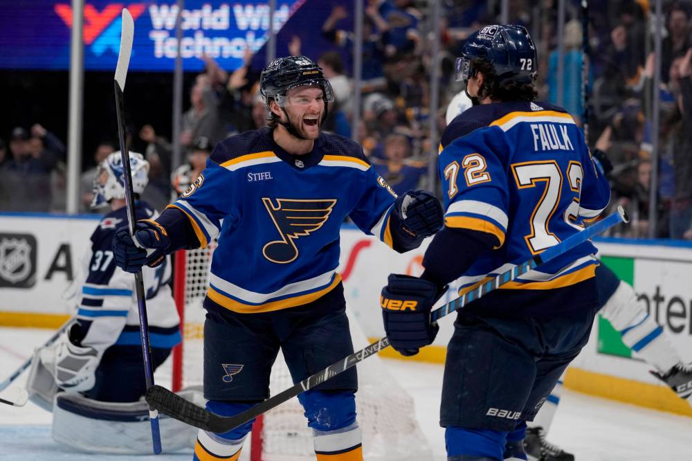 JEFF ROBERSON / THE ASSOCIATED PRESS
St. Louis Blues’ Nathan Walker is congratulated by teammate Justin Faulk (72) after scoring past Winnipeg Jets goaltender Connor Hellebuyck (37) during the second period of an NHL hockey game Sunday in St. Louis.