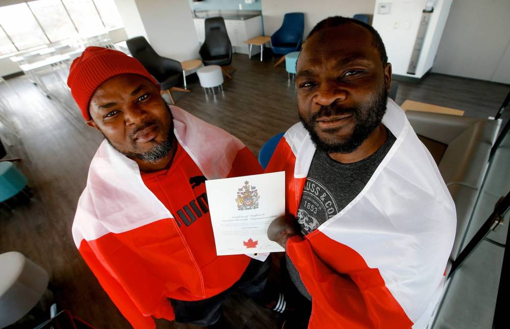 JOHN WOODS / WINNIPEG FREE PRESS
Razak Iyal, left, and Seidu Mohammed, from Ghana, who lost their fingers to frostbite after walking across the U.S.-Canada border into Manitoba in 2016, have become full Canadian citizens.