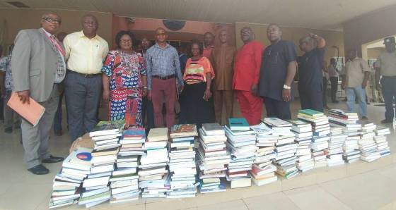 Uche Nwankwo (fourth from left) with books and study materials being donated to a school in Nigeria.(Supplied)