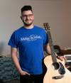 Winnipegger Dylan Bromley, who is a volunteer with Make-a-Wish Canada, enjoys playing the guitar. (Brook Jones / Winnipeg Free Press)
