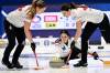 Briane Harris (left) and Shannon Birchard sweep Team Canada skip Kerri Einarson's shot Friday in World Women&rsquo;s Curling Championship action between Denmark and Canadain Sandviken, Sweden. (Jonas Ekstromer / TT News Agency via AP)
