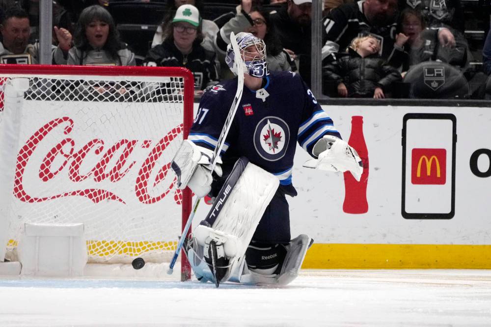 MARCIO JOSE SANCHEZ / THE ASSOCIATED PRESS
Winnipeg Jets goaltender Connor Hellebuyck gives up a goal on a shot from Los Angeles Kings defenseman Drew Doughty during the third period of an NHL hockey game Saturday in Los Angeles.