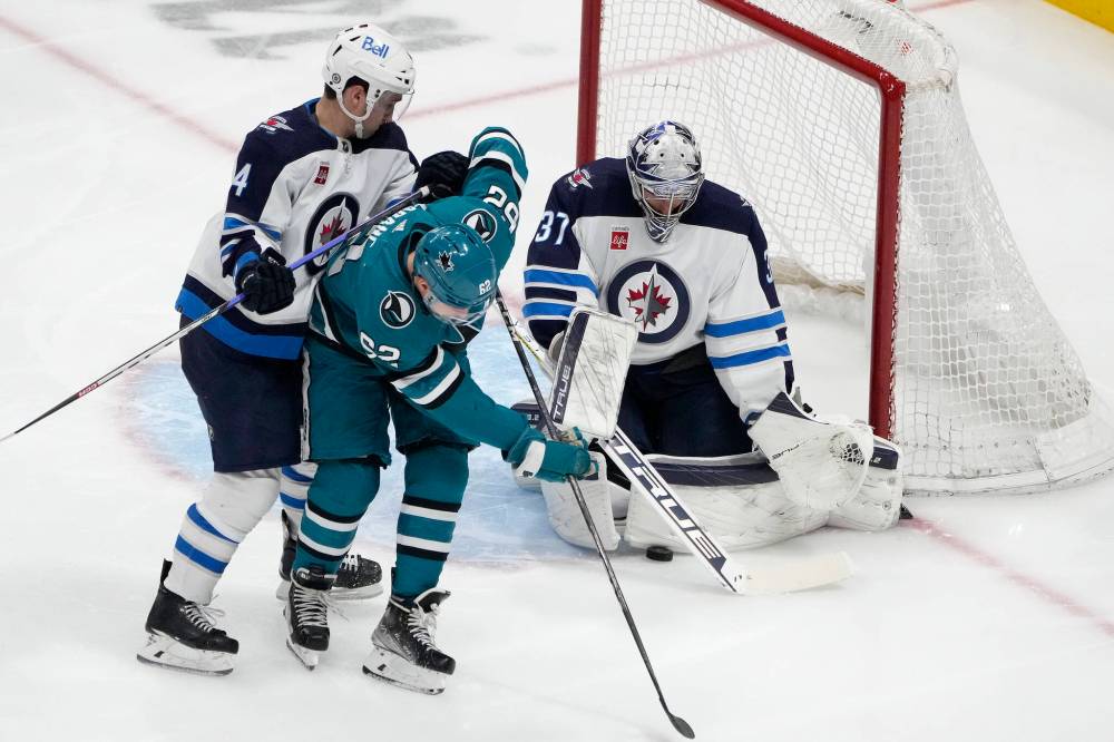 (AP Photo/Tony Avelar)
San Jose Sharks right wing Kevin Labanc tips the puck past Winnipeg Jets goaltender Connor Hellebuyck during the third period.