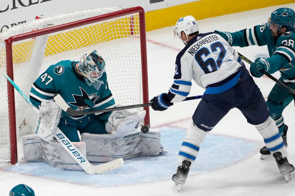 (AP Photo/Tony Avelar)
San Jose Sharks goaltender James Reimer makes a save against Winnipeg Jets right wing Nino Niederreiter Tuesday in San Jose.