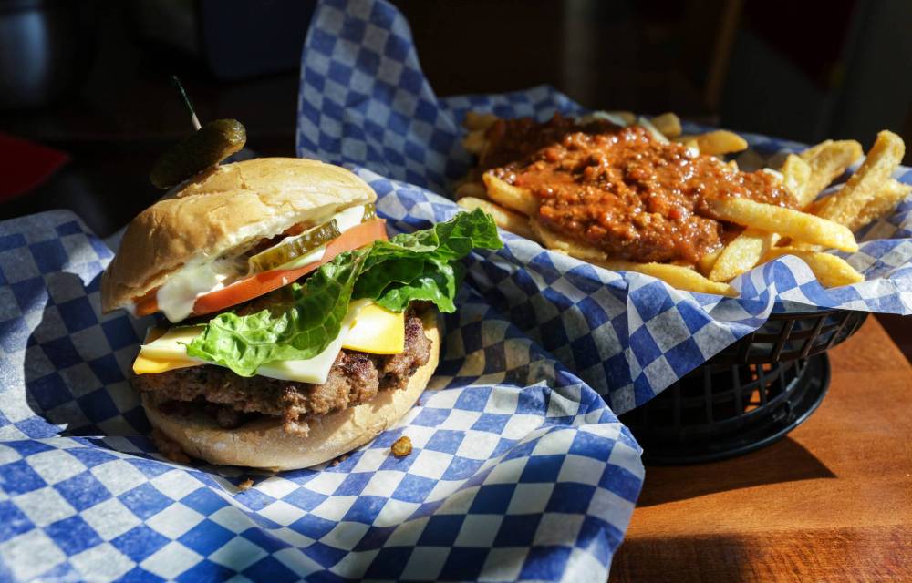RUTH BONNEVILLE / WINNIPEG FREE PRESS
What Nikhil and Kiran came to realize from talking with passers-by was that Kildonan Park is a huge factor in their restaurant’s end of the city, especially in summer. What goes better at a family picnic in the park than burgers, hotdogs and fries?