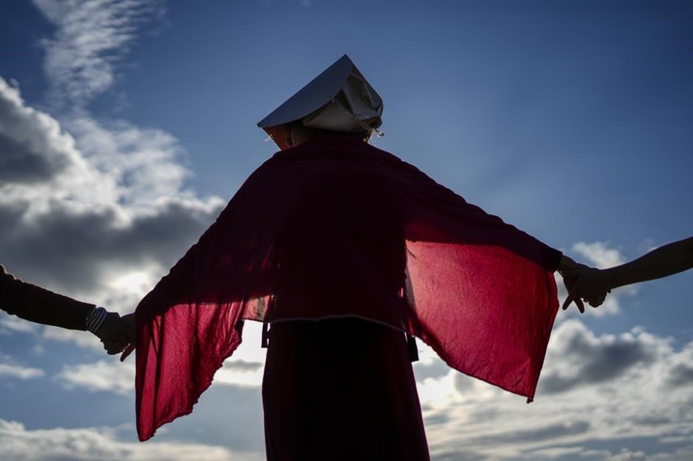 Israeli women's rights activists form a human chain to mark International Women's Day and protest against plans by Prime Minister Benjamin Netanyahu's new government to overhaul the judicial system, in Haifa, Israel, Wednesday, March 8, 2023. (AP Photo/Ariel Schalit)