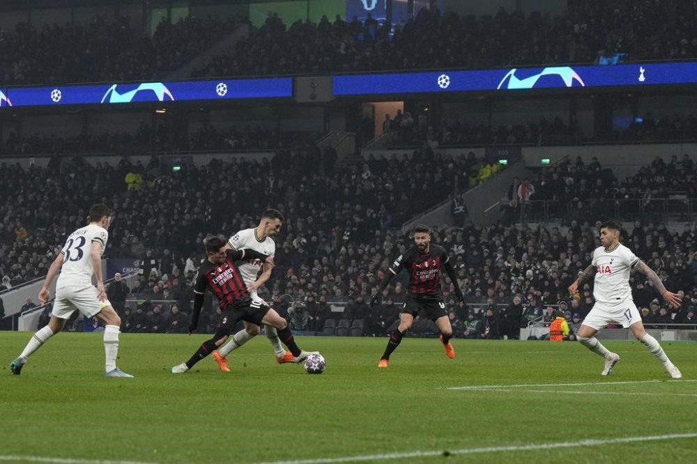 AC Milan's Brahim Diaz tries to hold off Tottenham's Ivan Perisic during the Champions League round of 16 second leg soccer match between Tottenham Hotspur and AC Milan at the Tottenham Hotspur stadium in London, Wednesday, March 8, 2023. (AP Photo/Alastair Grant)