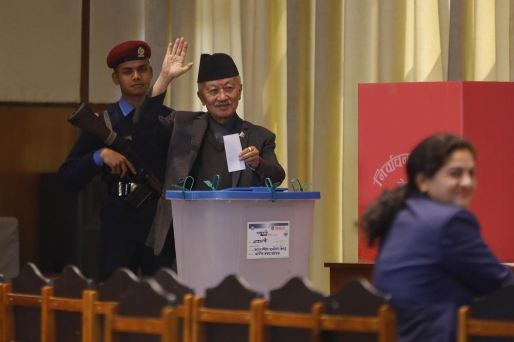 Presidential candidate Subhas Nembang of the Communist Party of Nepal (Unified Marxist-Leninist) waves before casting his vote for Nepal's new president in Kathmandu, Nepal, Thursday, March 9, 2023. Nepal's parliament members lined up Thursday to elect a new president the third one since the Himalayan nation abolished a centuries-old monarchy and the country was turned into a republic. The election for the president has fuelled feuds among the main political parties and triggered political uncertainty. (AP Photo/Bikram Rai)