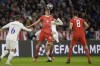 Bayern's Josip Stanisic, foreground, challenges for the ball with PSG's Fabian Ruiz during the Champions League round of 16 second leg soccer match between Bayern Munich and Paris Saint Germain at the Allianz Arena in Munich, Germany, Wednesday, March 8, 2023. (AP Photo/Andreas Schaad)